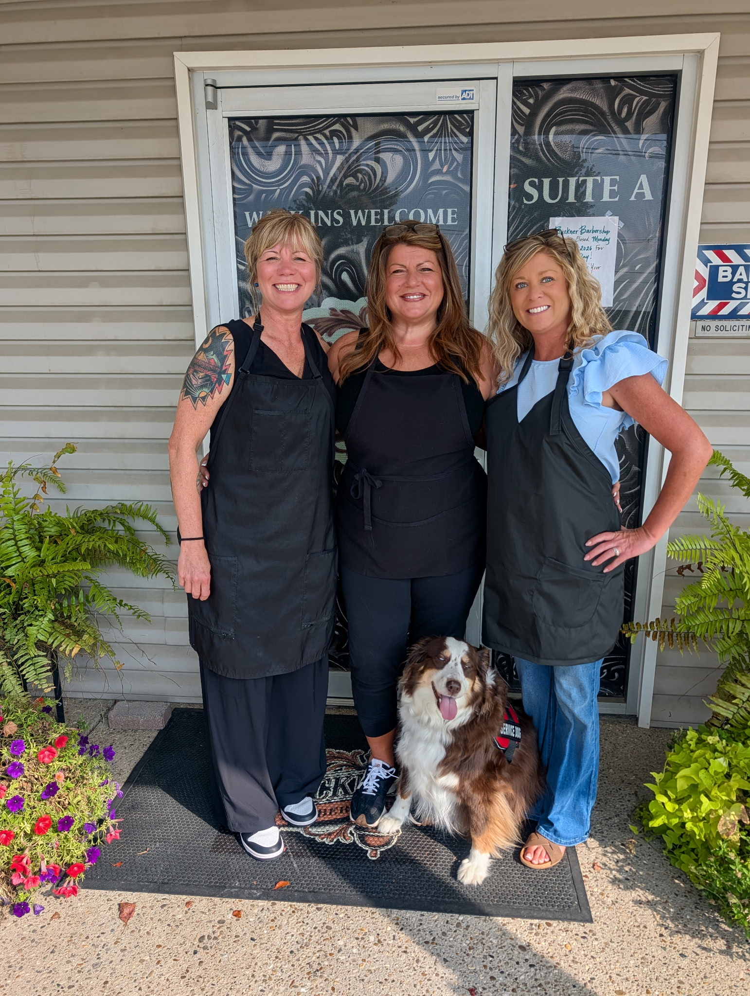 Buckner Barber Shop team and shop dog outside the storefront